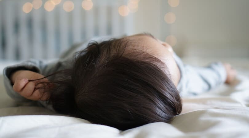 Picture of the top of a sleeping child's head after doing sleep training successfully.
