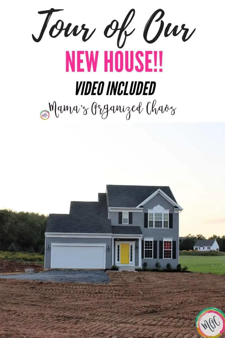 charcoal grey house with yellow door in the country