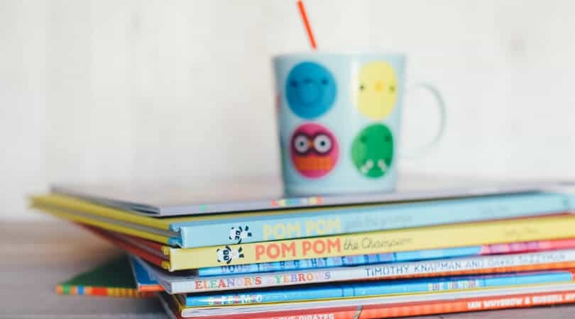 Children's books stacked up for the toddler refusing to nap and doing rest time rules instead.