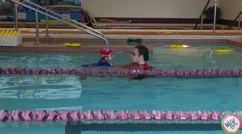 British Swim School- A Girl and Her Goggles turtle 1 level british swim school working with instructor on putting face in water.