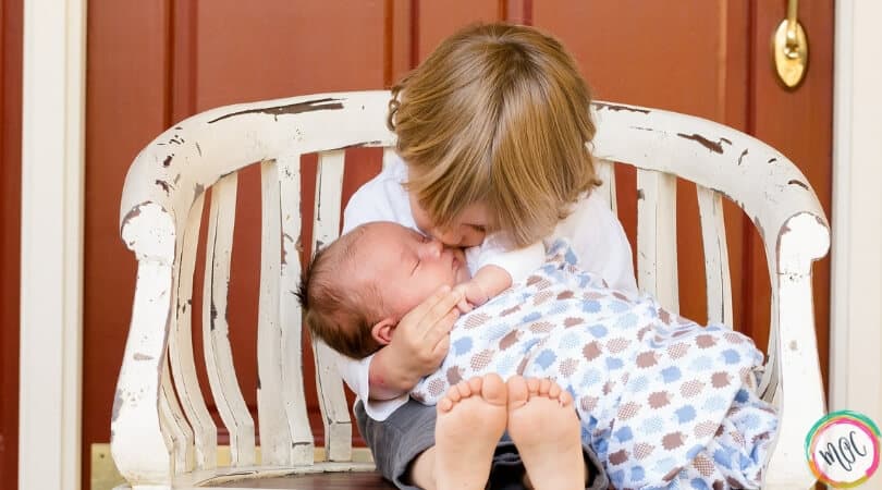 Child holding baby- why this family won't be second guessing the use of babywise this time around.