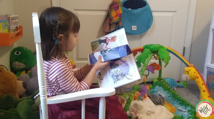 Caroline reading a book in her rocking chair