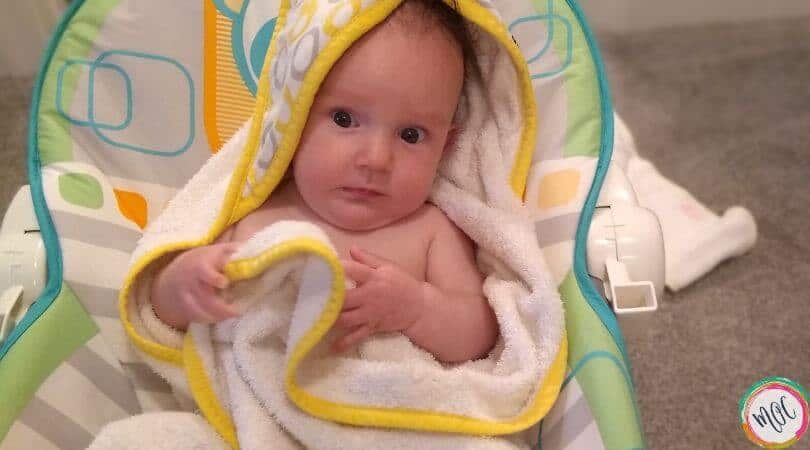 5 month old baby wrapped in towel after bath