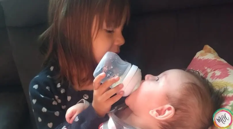 4 year old feeding 4 month old a bottle