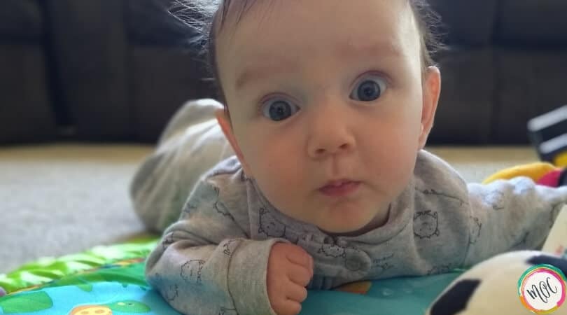 happy 4 month old baby doing tummy time