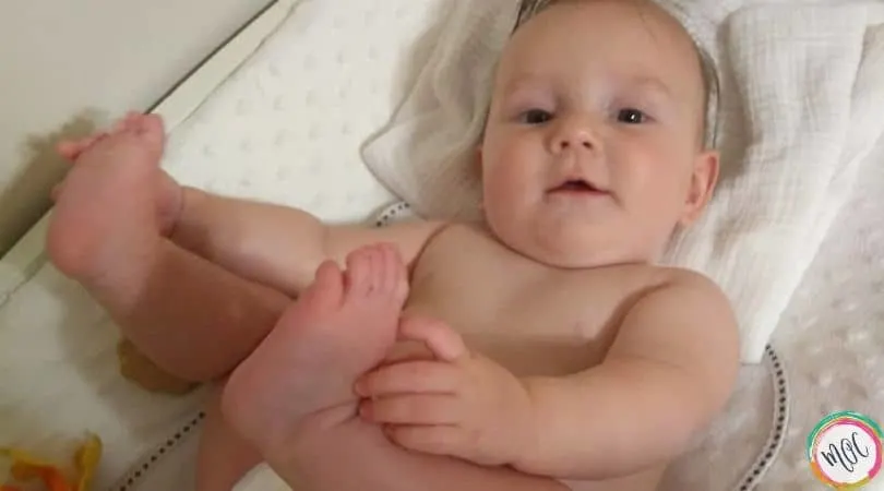 6 month old baby touching toes
