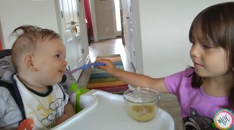 4 year old feeding 6 month old solid food