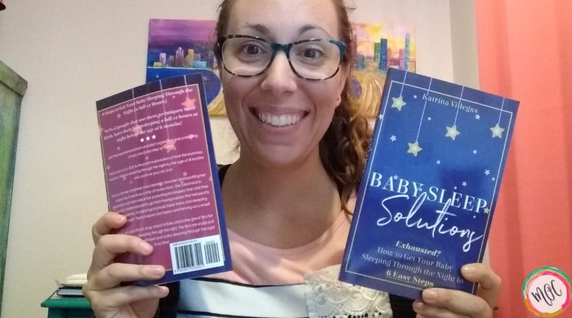 Baby Sleep Solutions Book author holding baby sleep solutions book